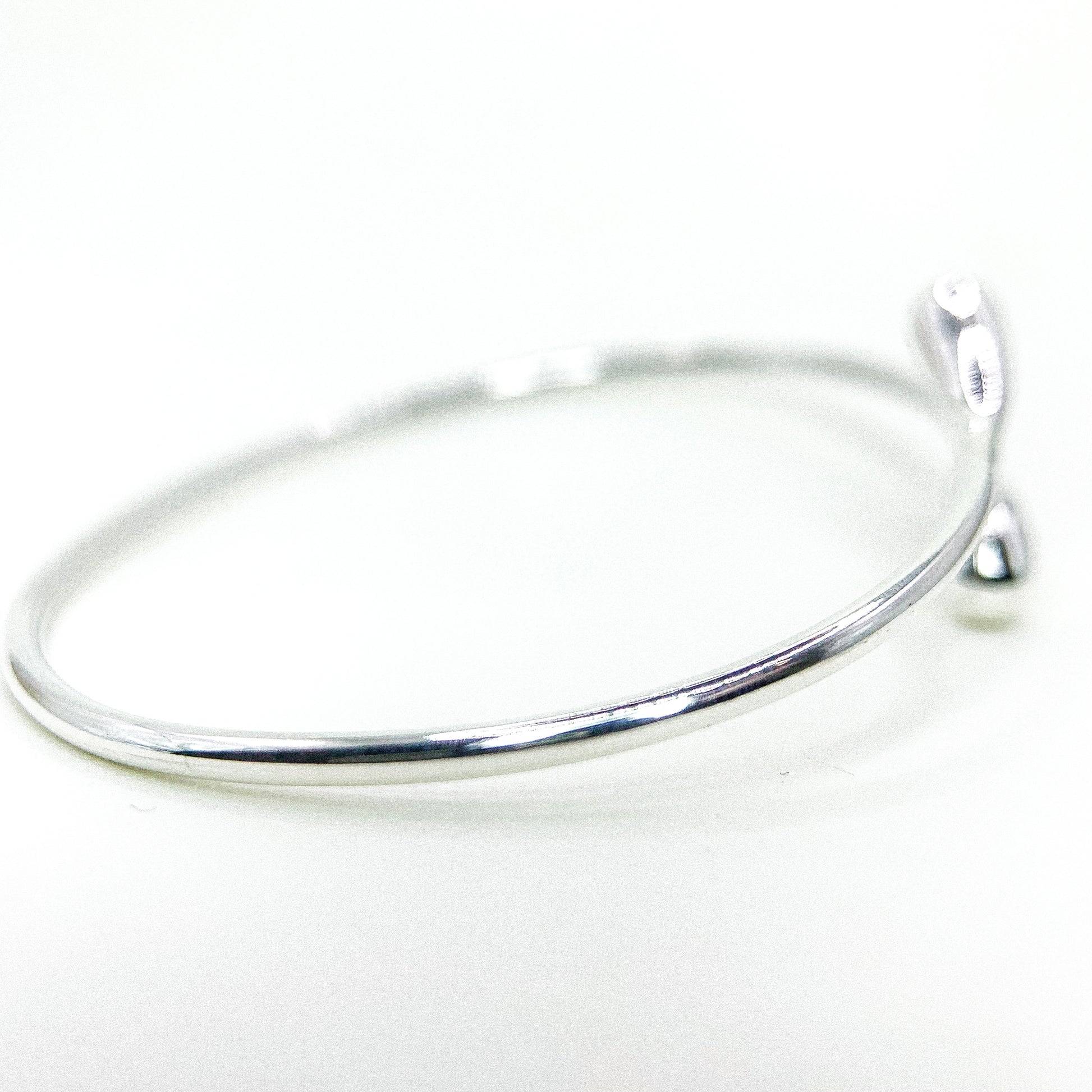 Drop Twist Open Silver Bangle — detail view